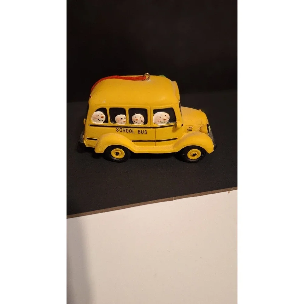 Resin school bus Christmas ornament with Santa and children